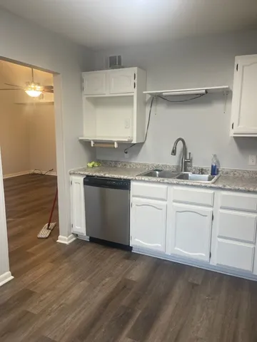 a kitchen with a sink a stove and cabinets