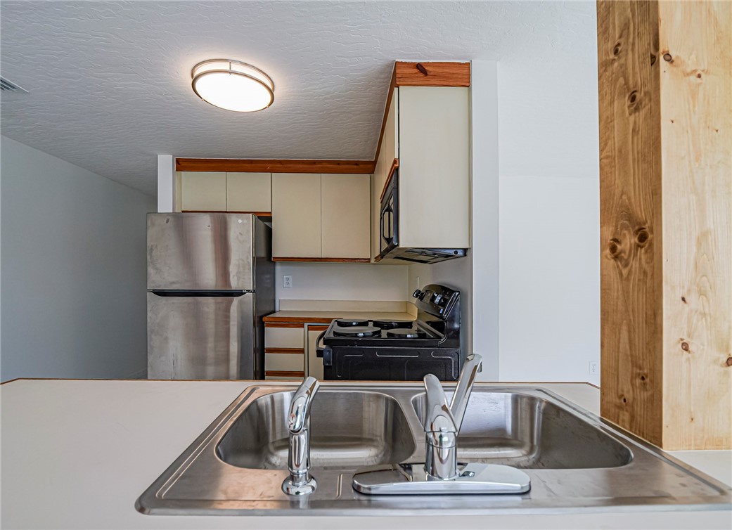 8520 Highway 1, Unit H12 Sebastian, FL 32976 - Photo 19 of 35 a kitchen with a refrigerator and a sink