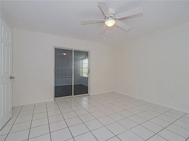 an empty room with closet and fan