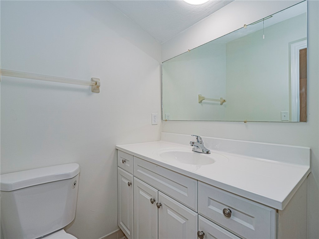 8520 Highway 1, Unit H12 Sebastian, FL 32976 - Photo 30 of 35 a bathroom with a sink toilet and vanity