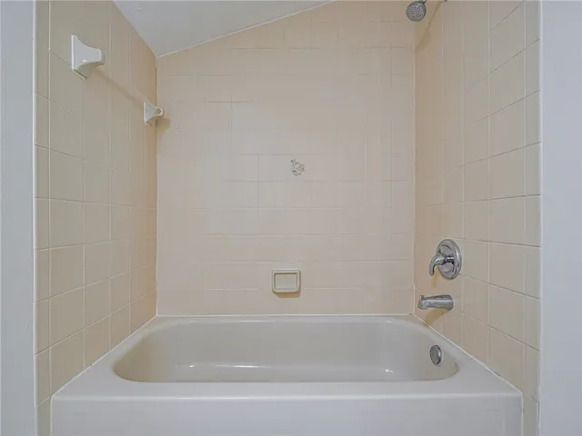 a white bath tub and shower