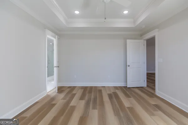 a view of hallway with wooden floor