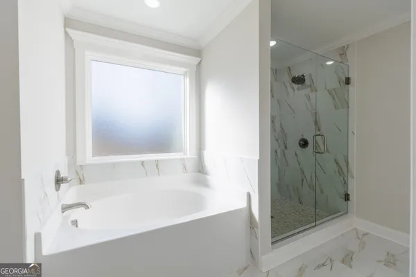 a bathroom with a bathtub and shower