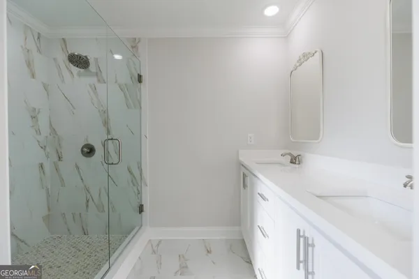a bathroom with a double vanity sink and mirror