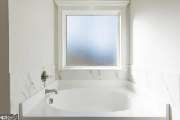 a white bath tub sitting next to a white sink