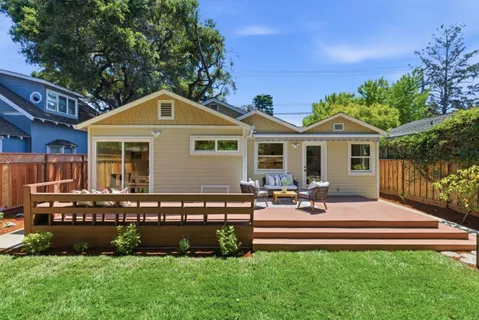 a front view of a house with a garden and patio