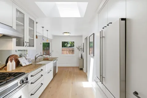 a kitchen with stainless steel appliances a refrigerator and a sink