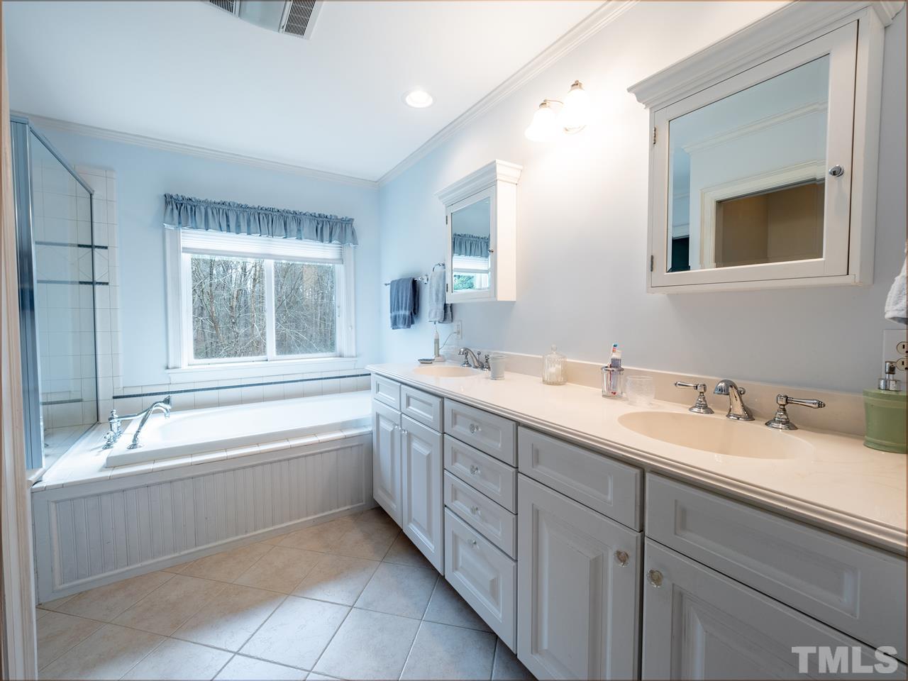 1000 Arrow Leaf Circle Cary, NC 27519 - Photo 13 of 25 a bathroom with a granite countertop sink mirror and bathtub