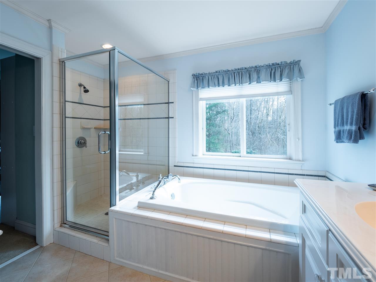 1000 Arrow Leaf Circle Cary, NC 27519 - Photo 14 of 25 a bathroom with a tub sink and mirror