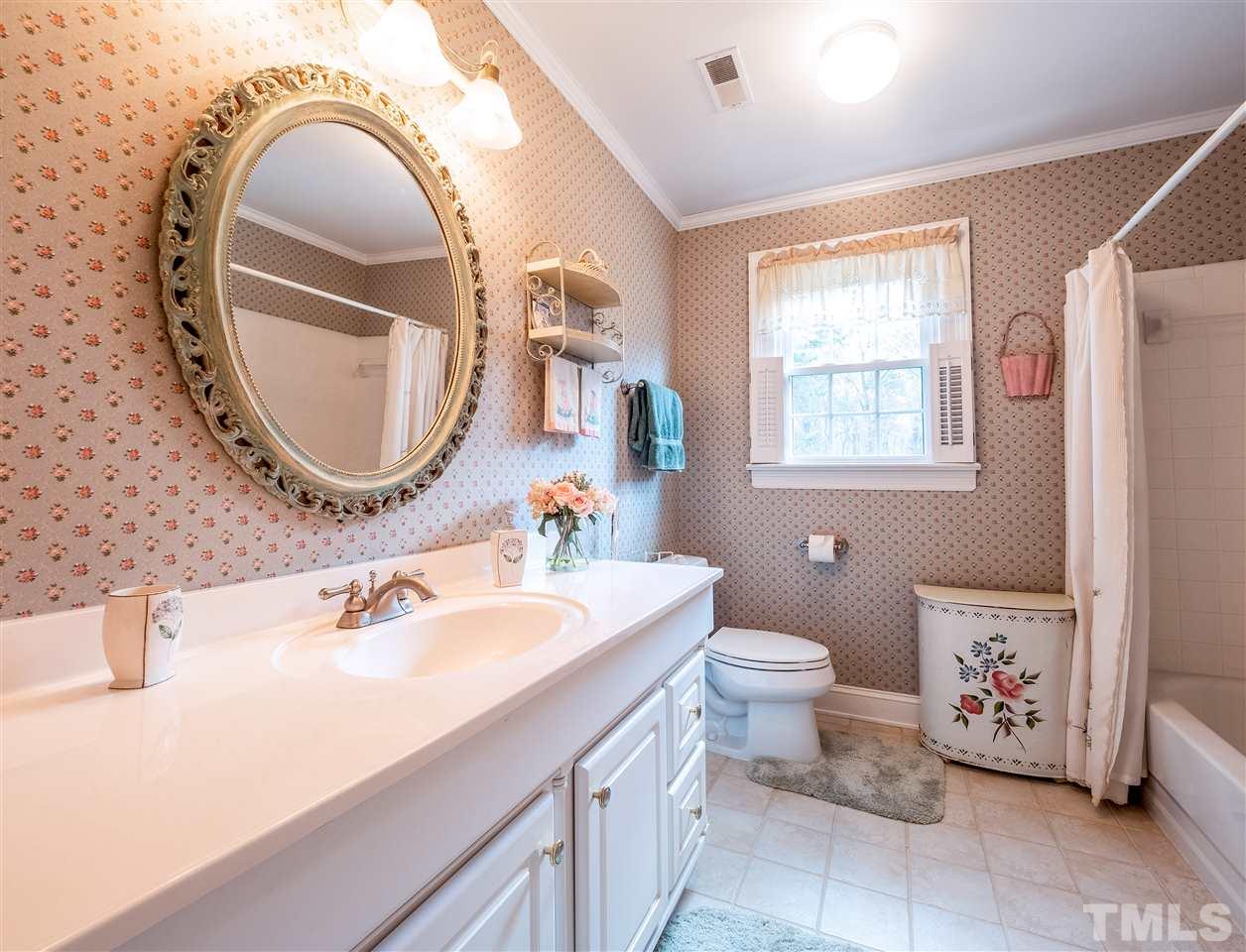 1000 Arrow Leaf Circle Cary, NC 27519 - Photo 17 of 25 a bathroom with a toilet a sink and a mirror