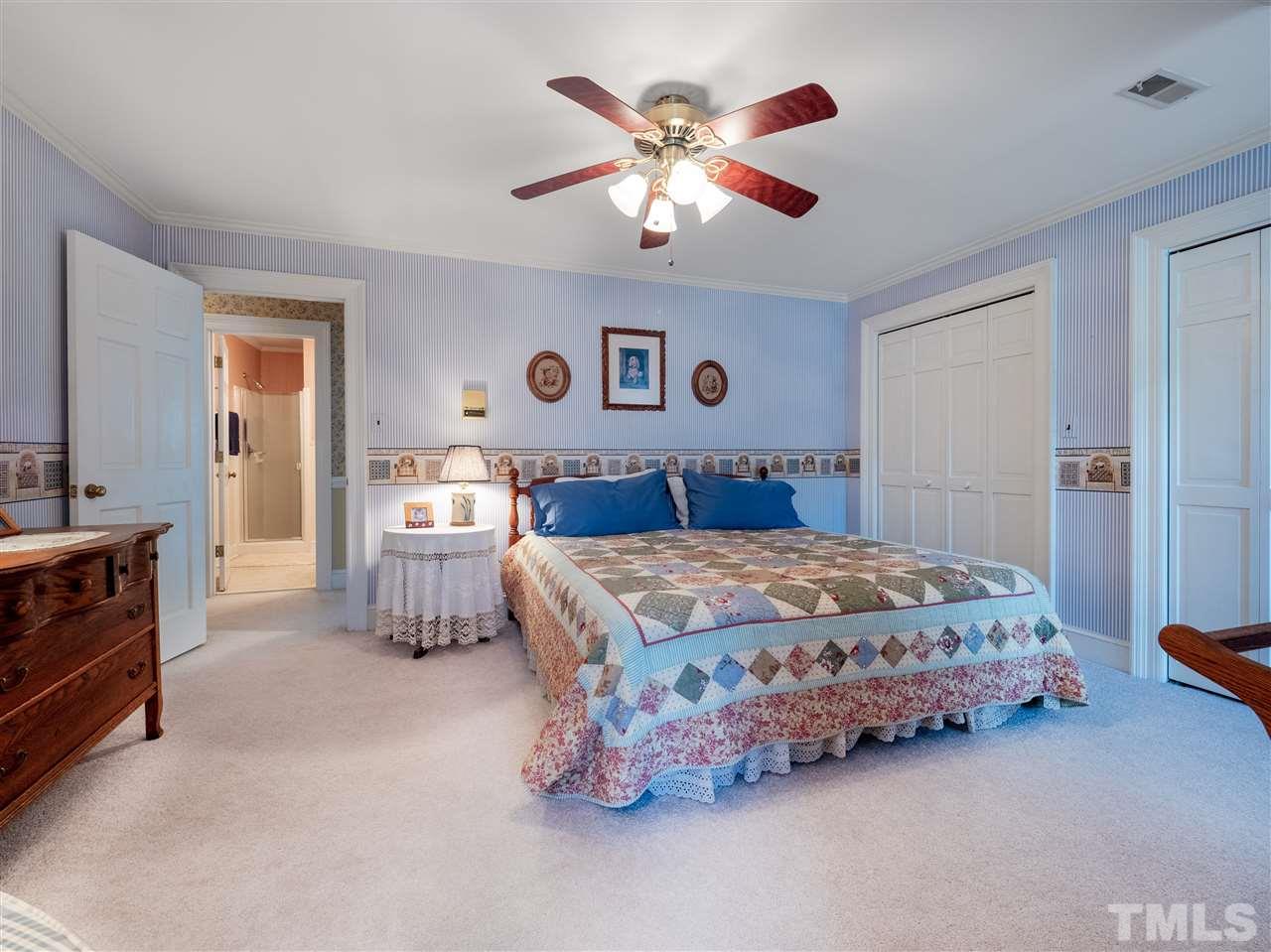 1000 Arrow Leaf Circle Cary, NC 27519 - Photo 18 of 25 a bedroom with a bed and a chandelier