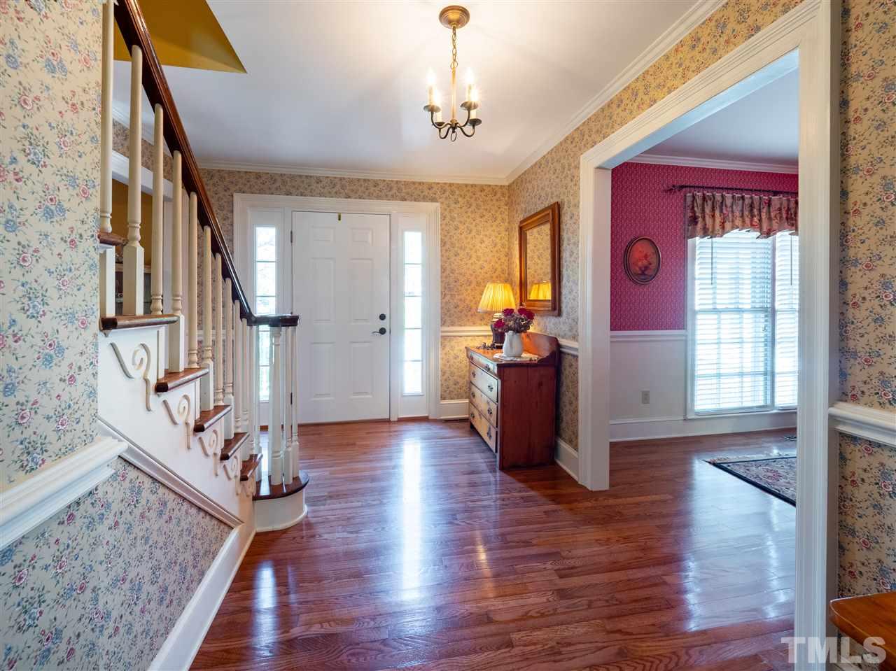 1000 Arrow Leaf Circle Cary, NC 27519 - Photo 22 of 25 a view of a hallway with wooden floor and staircase