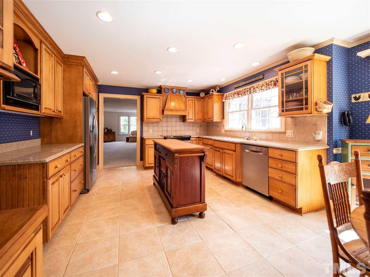1000 Arrow Leaf Circle Cary, NC 27519 - Photo 6 of 25 a large kitchen with stainless steel appliances granite countertop a stove and a sink