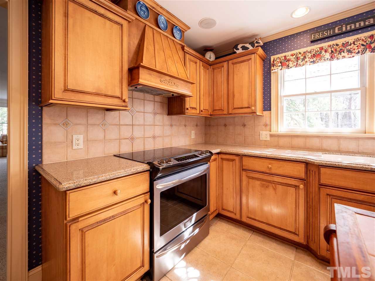 1000 Arrow Leaf Circle Cary, NC 27519 - Photo 7 of 25 a kitchen with stainless steel appliances granite countertop a sink a stove and a refrigerator