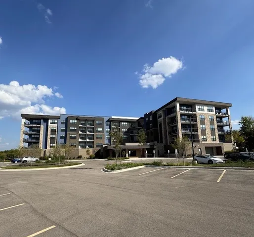 a view of a building with cars parked