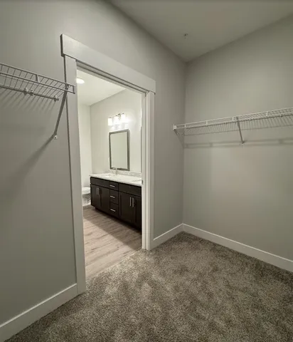 a bathroom with a double vanity sink and a mirror