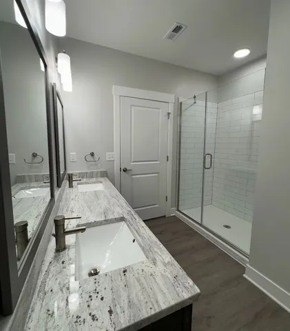 a bathroom with a glass shower door