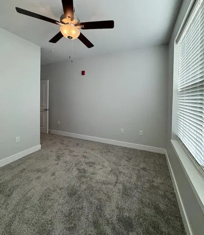 a bathroom with a granite countertop sink a toilet and a mirror