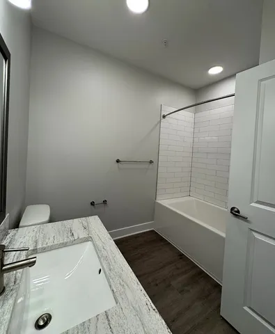 a bathroom with a bathtub and a shower