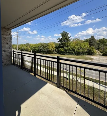 a view of balcony with wooden floor and fence