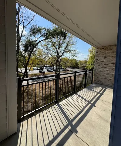 a living room with furniture wooden floor and large windows