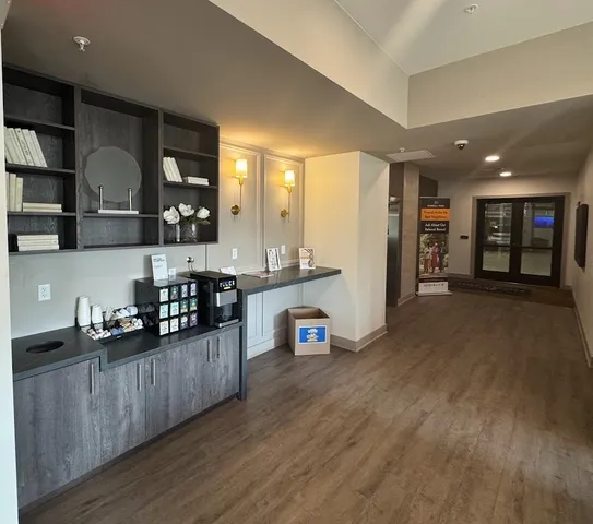 a lobby with furniture and a potted plant