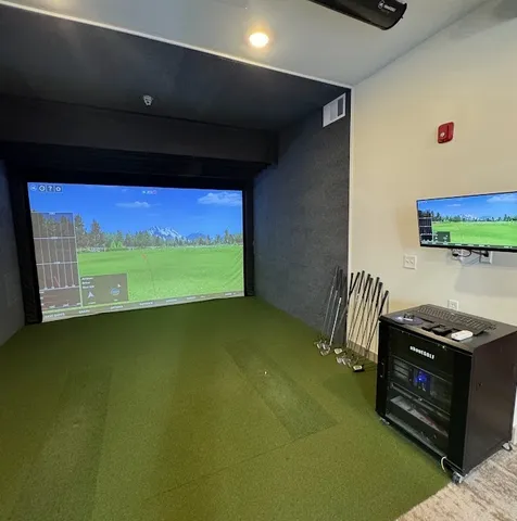 a living room with pool table gym equipment