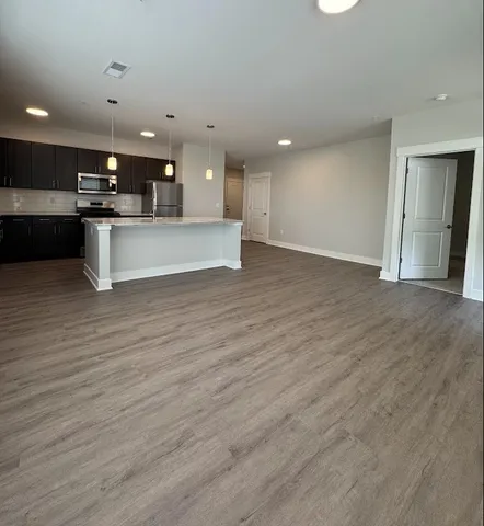 an empty room with windows and ceiling fan view