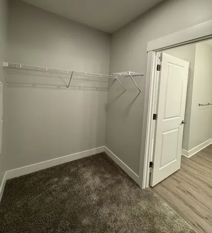 a view of a hallway with a bathroom