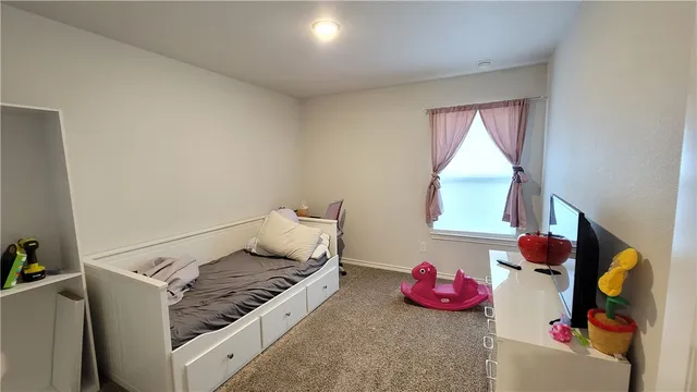 a bedroom with bed and a window