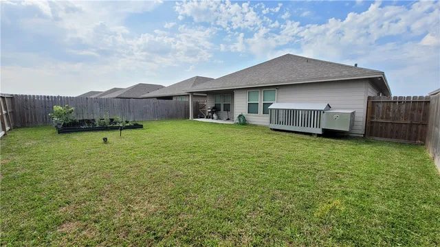 a view of a house with a yard and sitting area