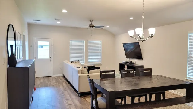 a view of a dining room with furniture and wooden floor