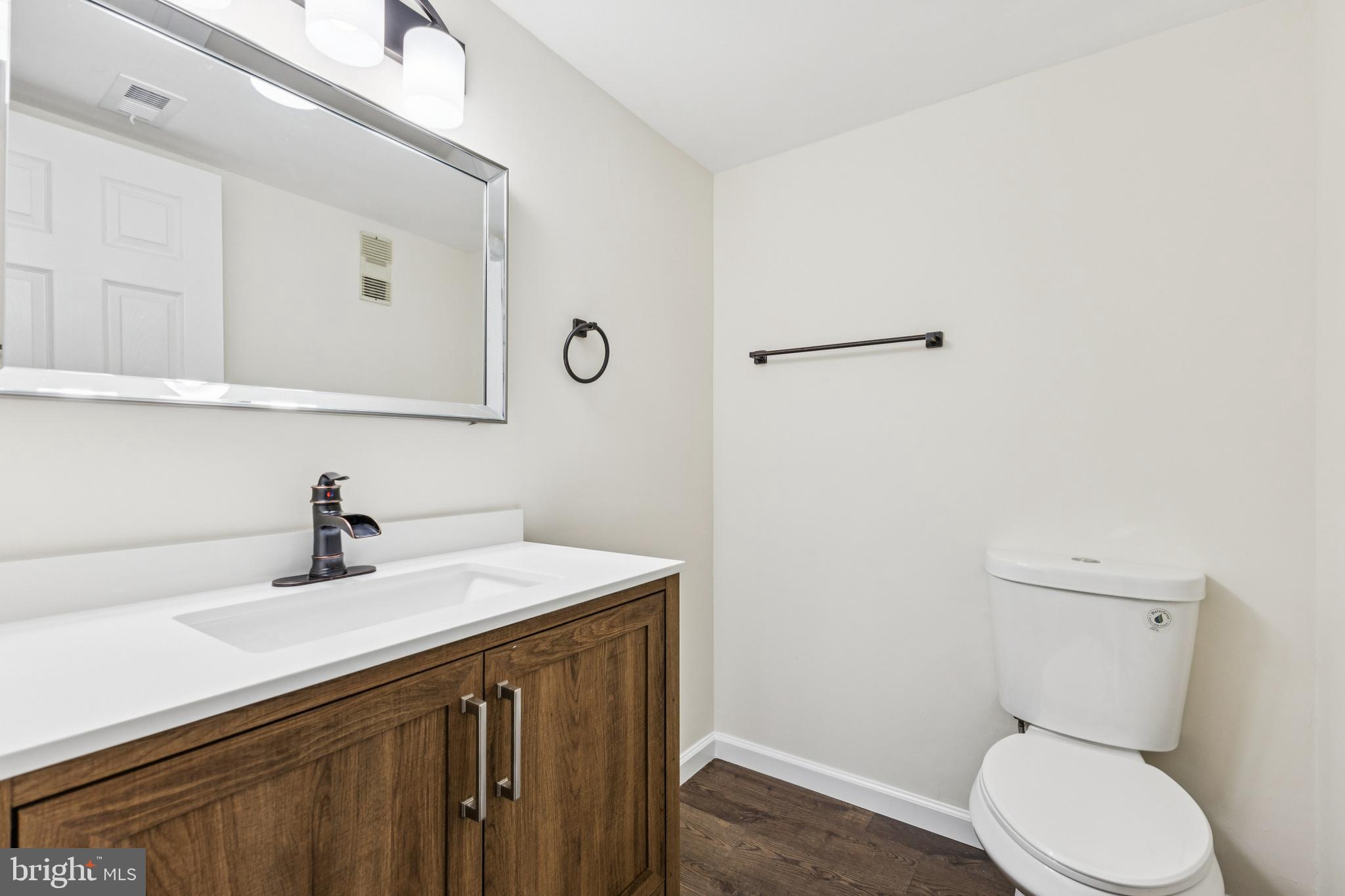 2015 Wethersfield Court Reston, VA 20191 - Photo 12 of 24 a bathroom with a sink a toilet and mirror