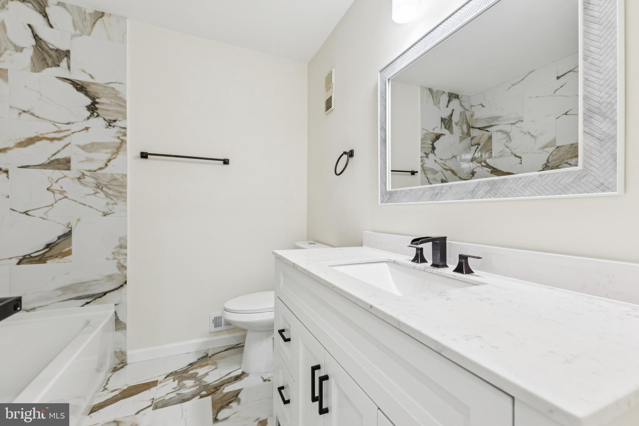 2015 Wethersfield Court Reston, VA 20191 - Photo 13 of 24 a bathroom with a sink mirror vanity and toilet