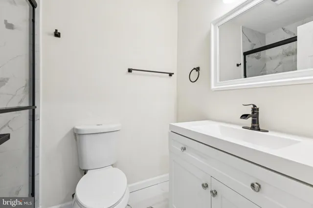 a bathroom with a sink a toilet and mirror
