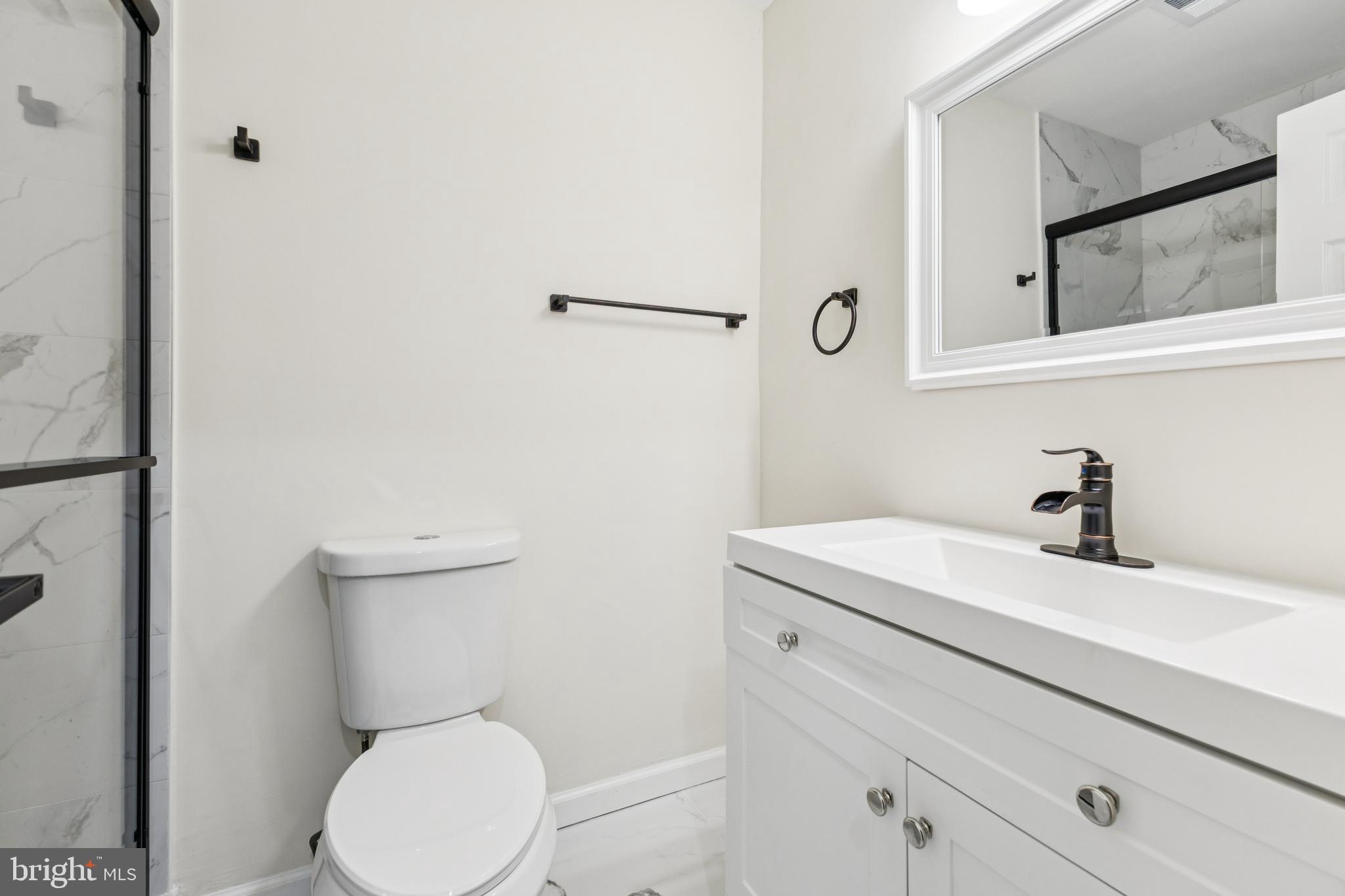 2015 Wethersfield Court Reston, VA 20191 - Photo 18 of 24 a bathroom with a sink a toilet and mirror