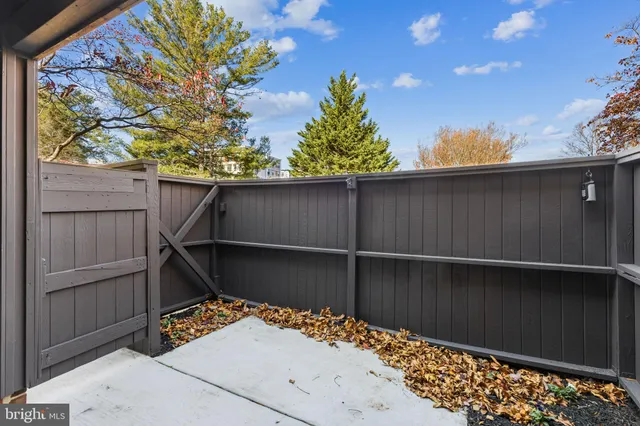 a wooden bench sitting in front of a building