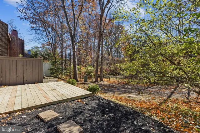 a view of backyard with wooden fence