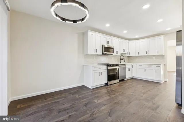 a kitchen with a white cabinets and white appliances