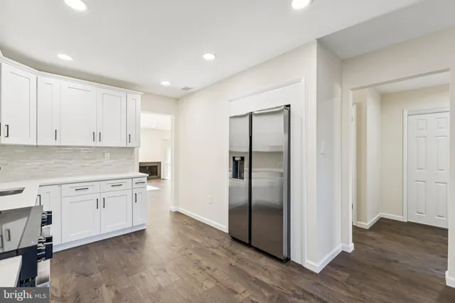 a kitchen with a refrigerator sink and cabinets