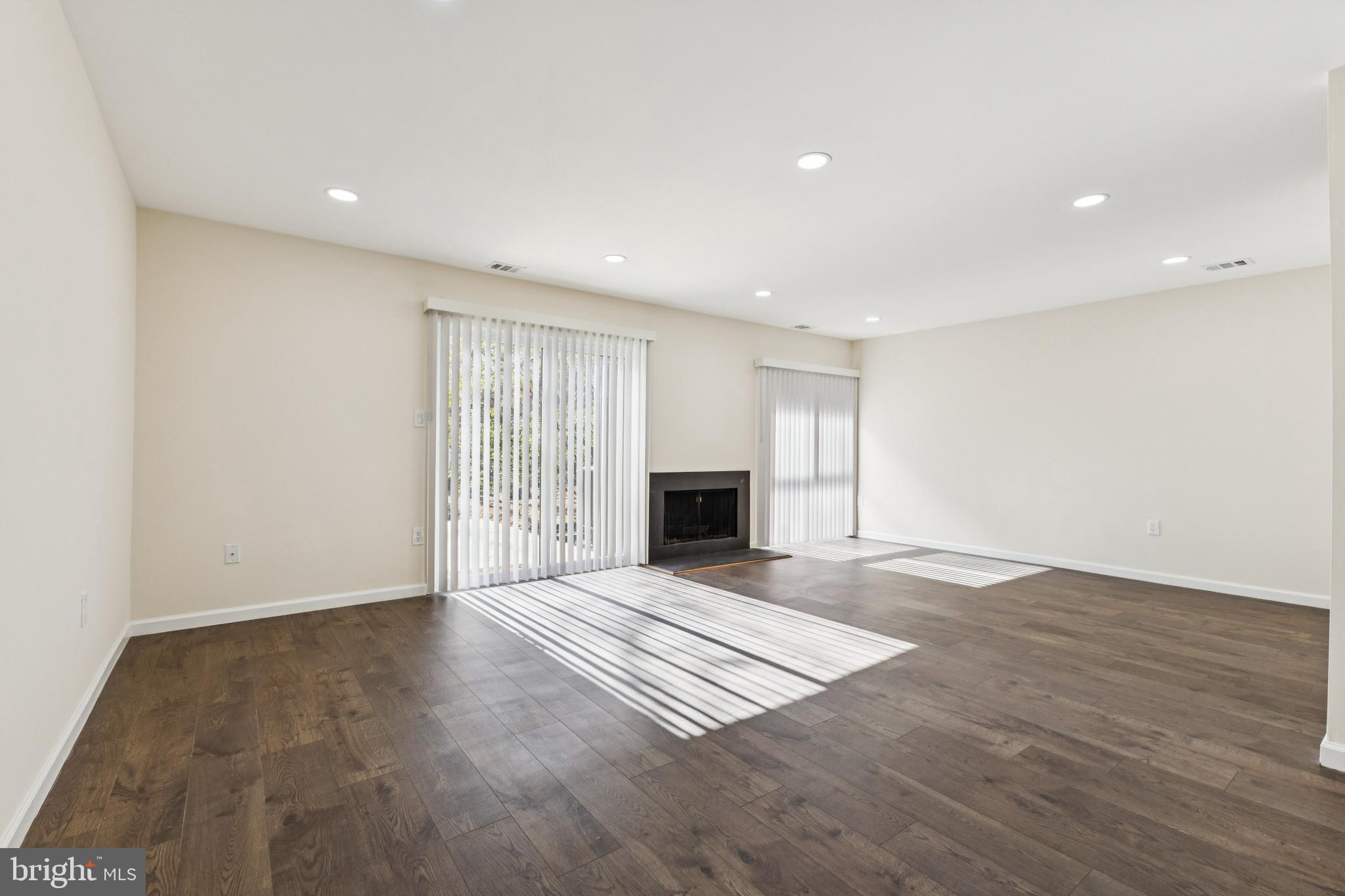2015 Wethersfield Court Reston, VA 20191 - Photo 8 of 24 a view of an empty room with a fireplace and a window