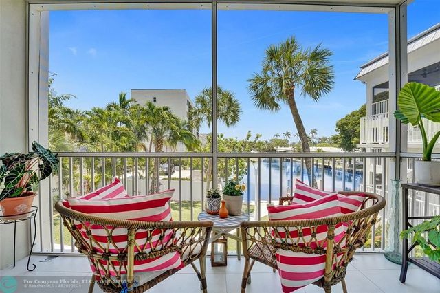a balcony with furniture and a potted plant