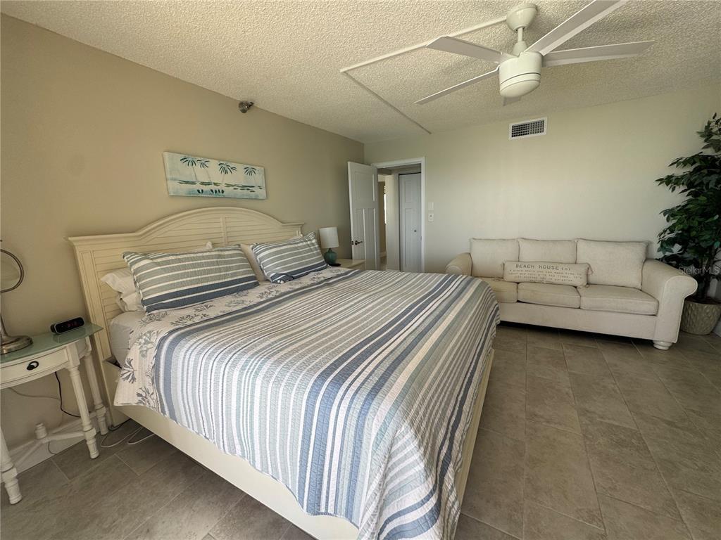 15000 Gulf Boulevard, Unit 1108 Madeira Beach, FL 33708 - Photo 13 of 20 a bedroom with a bed and a chandelier