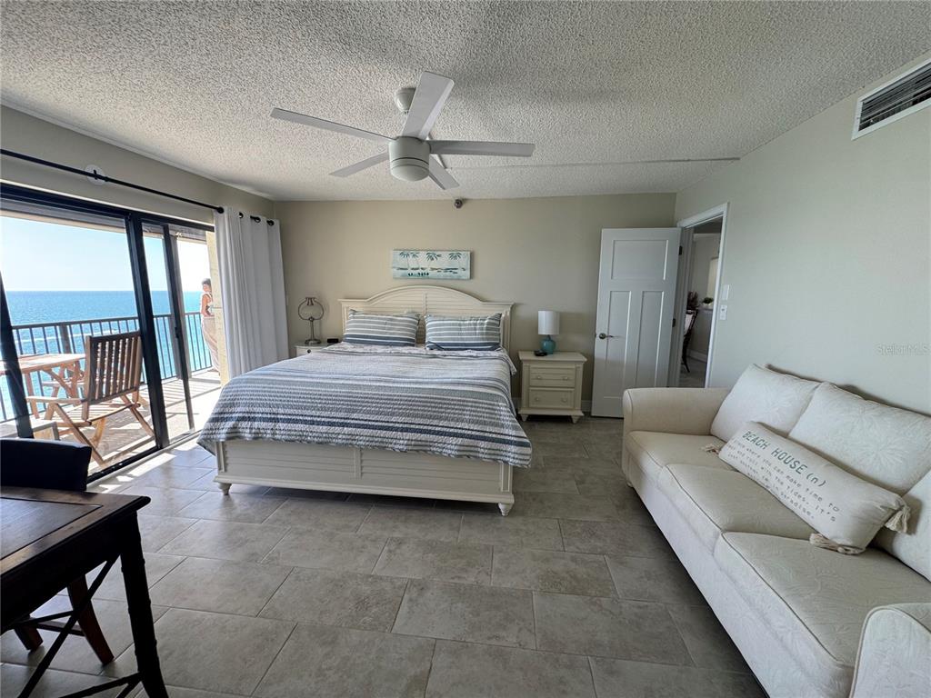 15000 Gulf Boulevard, Unit 1108 Madeira Beach, FL 33708 - Photo 14 of 20 a bedroom with a bed and a couch