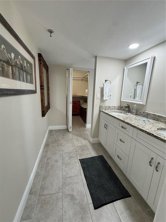 15000 Gulf Boulevard, Unit 1108 Madeira Beach, FL 33708 - Photo 16 of 20 a spacious bathroom with a double vanity sink and a mirror