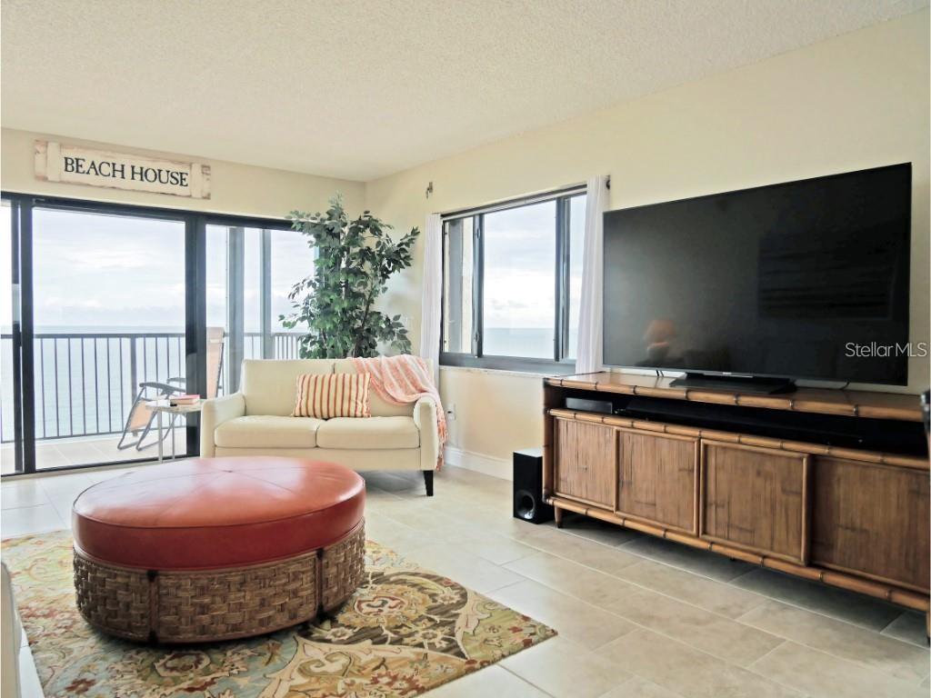 15000 Gulf Boulevard, Unit 1108 Madeira Beach, FL 33708 - Photo 7 of 20 a living room with furniture and a flat screen tv