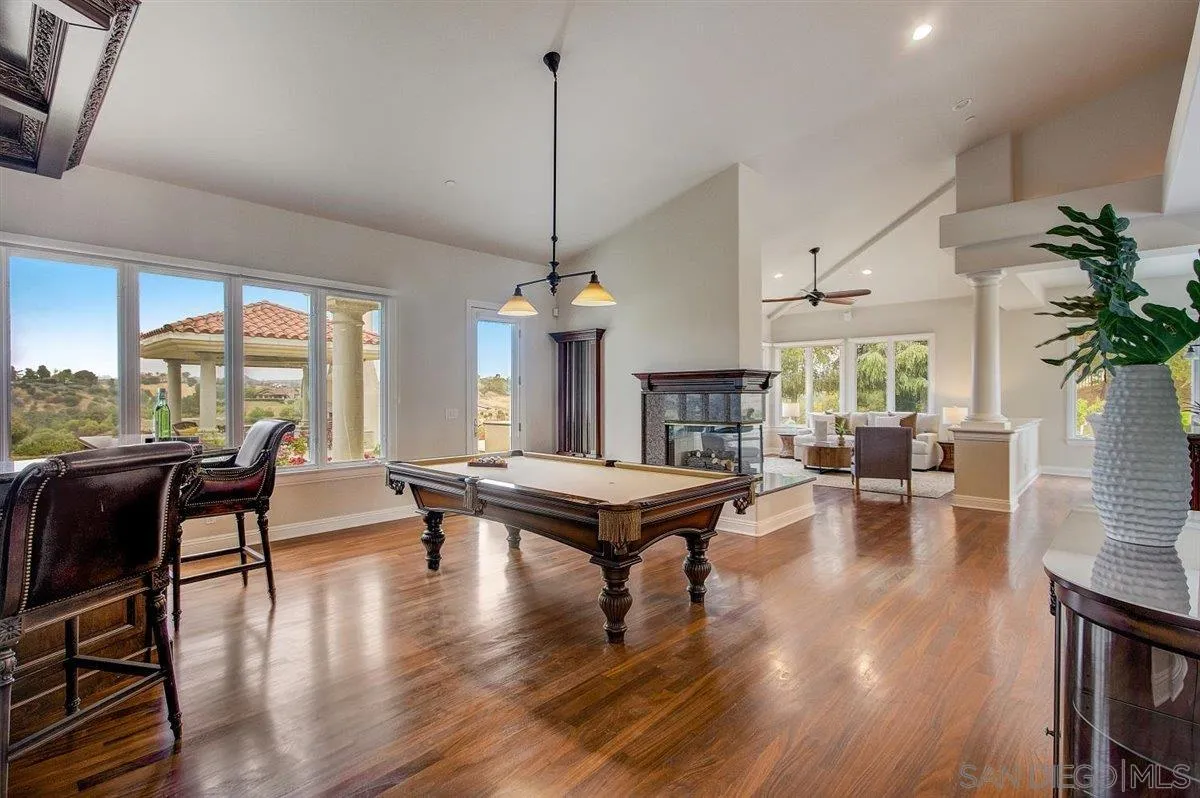 4349 Fallsbrae Road Fallbrook, CA 92028 - Photo 11 of 68 a living room with fireplace furniture dining table and a large window
