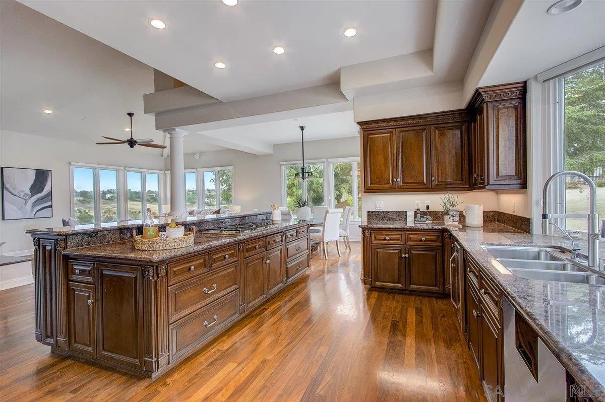 4349 Fallsbrae Road Fallbrook, CA 92028 - Photo 15 of 68 a kitchen with stainless steel appliances granite countertop a stove and a sink