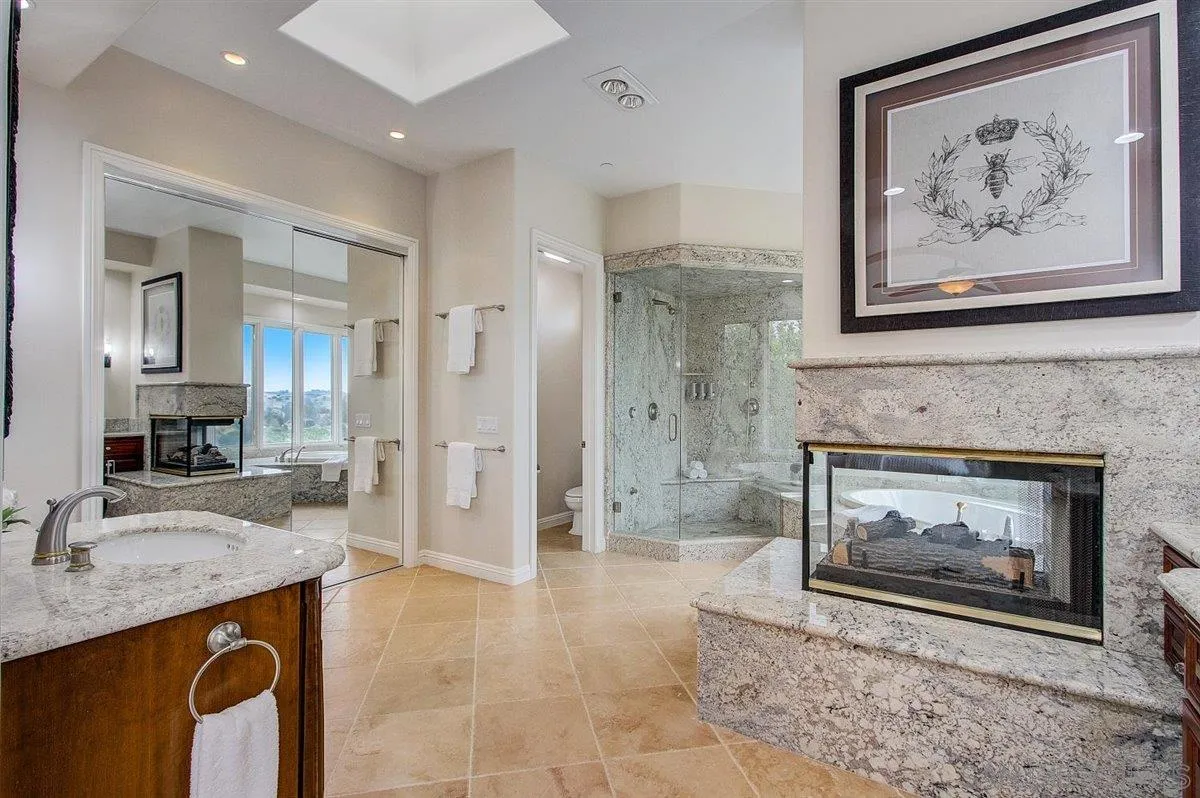 4349 Fallsbrae Road Fallbrook, CA 92028 - Photo 22 of 68 a spacious bathroom with a granite countertop sink a toilet a mirror and shower