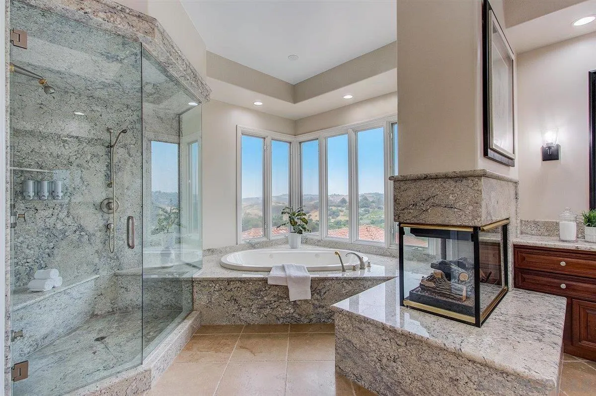 4349 Fallsbrae Road Fallbrook, CA 92028 - Photo 23 of 68 a living room with fireplace furniture and a floor to ceiling window